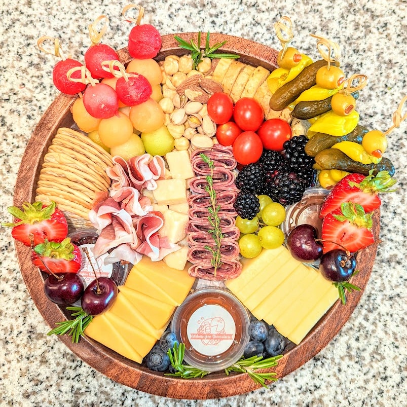 Charcuterie & Chill - Includes up to 3 artisanal cheeses, 2 cured meats, fresh & dried fruits, gourmet crunches, honey/preserves, sweet treats, garnish.
